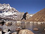 Gokyo Ri 01-2 Jerome Ryan Crossing Rocks From Gokyo To Start Climb To Gokyo Ri Jerome Ryan leaves Gokyo (4750m) and crosses the boulders at the end of the third Gokyo Lake to start the climb to Gokyo Ri (5345m).
